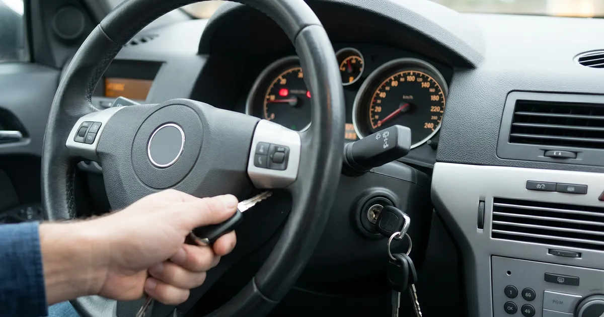 Car key stuck in ignition — hand trying to turn it — Locksmith Auto